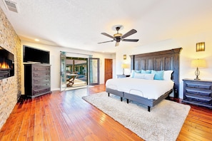A bedroom with a bed, a ceiling fan, a TV, and a fireplace. - Great Reviews w/ 7 Beds, Pool, Hot Tub & Fire Pit! (Temecula)