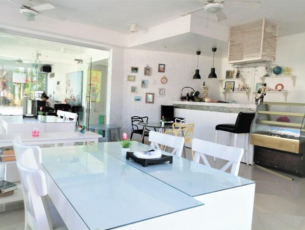 Enjoy meals in a stylish dining area with a glass-top table and comfortable seating.