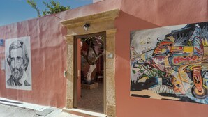A building with a mural of a colorful abstract design on the right side.