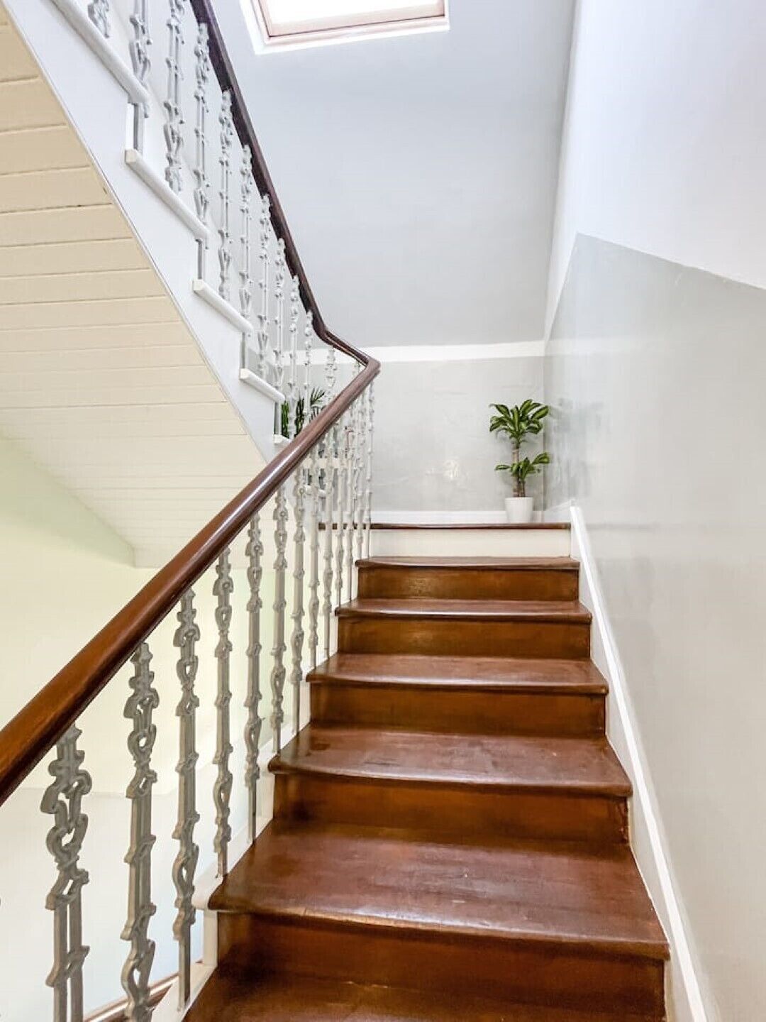 A staircase with wooden steps and white railings.