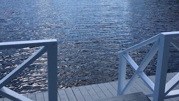 Guests can enjoy serene lake views from the deck, surrounded by dense forest.