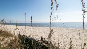 A beach with sand, sea, and tall grasses. - Oak Shores 155 | First Floor Unit, Just a Short Walk to the Beach! (Biloxi)