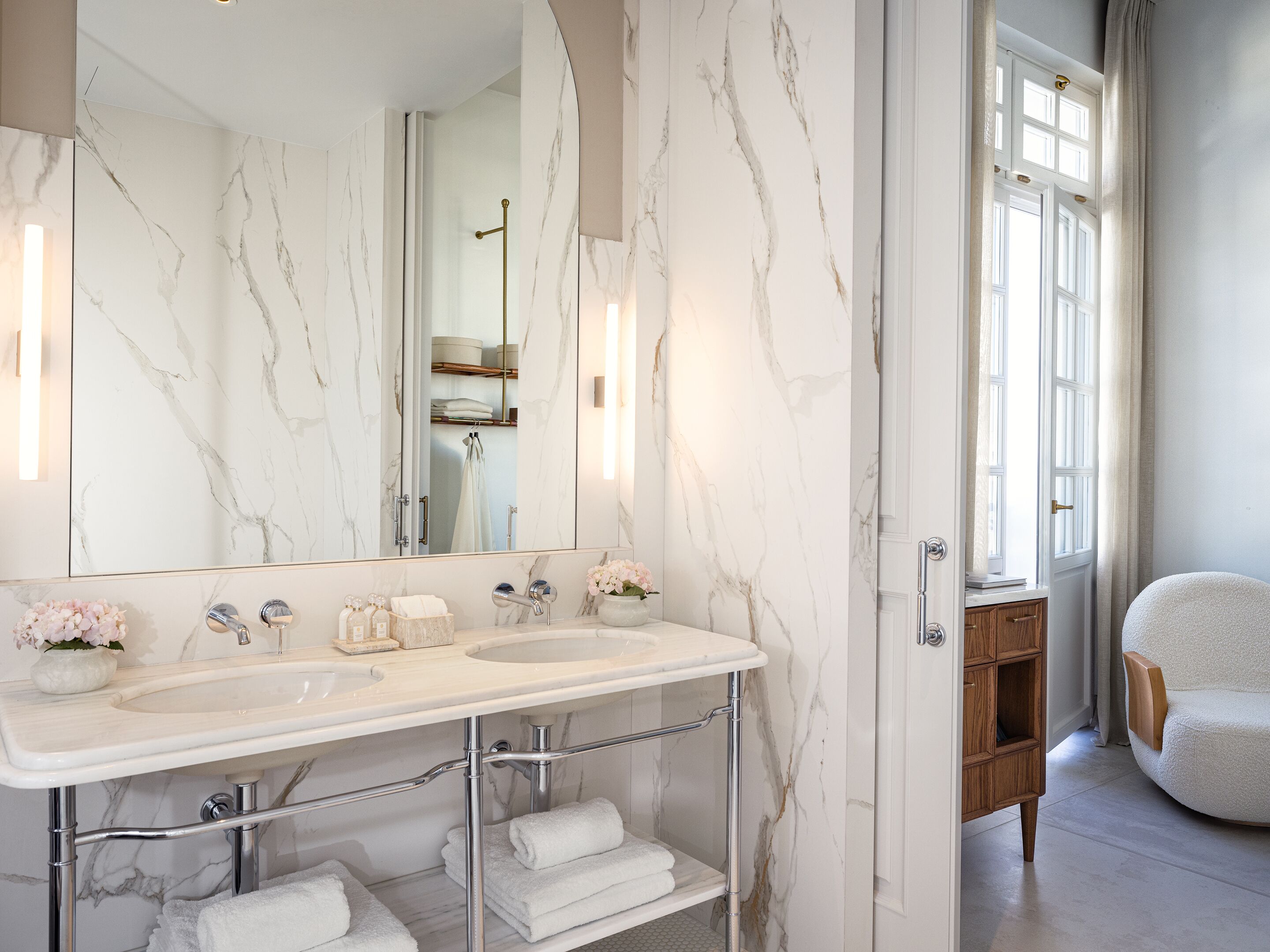 A bathroom with two sinks, a large mirror, and a wooden cabinet.
