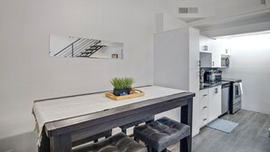 A modern kitchen with white cabinets, a black countertop, and a built-in oven. - Bar, restaurants, and attractions all nearby! (Phoenix)