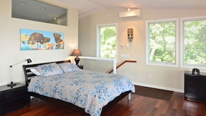 A bedroom with a bed, a nightstand, a lamp, a wall-mounted light fixture, and a window with blinds. - Unequalled Views of Reservoir & Mtns, Affordable, Totally Private (West Hurley)