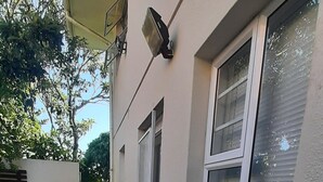 A house with a concrete pathway leading to a garage door. - Lovely Apartment in East London, South Africa (East London)