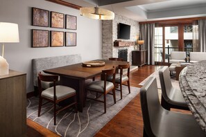 Enjoy meals in this stylish dining area with a dining table and six chairs, a mounted TV, and a fireplace.