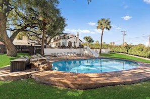 A swimming pool with a stone border, surrounded by a grassy area and a few lounge chairs. - Casa Canasa in charming San Antonio!!!! Must see!!! (San Antonio)