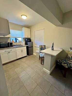 Fridge, microwave, stovetop, coffee/tea maker