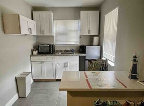 Fridge, microwave, stovetop, coffee/tea maker