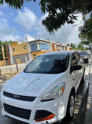 Guests can park their vehicle in front of this residential building with a modern design.