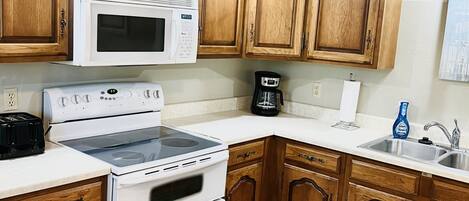 Microwave, oven, stovetop, dining tables