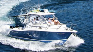 A boat named "Pretty Vane" with a registration number P-11358, moving through the water.