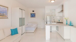 A modern, compact apartment with a kitchenette, a bed, and a sofa. - Villa Blanka - Six Bedroom Villa with Swimming Pool and Sea View (Podgora)