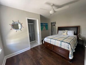 Rest in comfort with a large bed and ceiling fan, plus a convenient bedside table and closet with mirror.