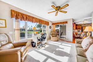 TV, books - Dog-friendly, golf course adjacent home with a pool, hot tub, & fitness center (Mesa)