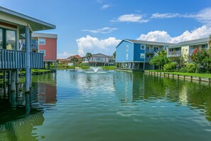 Guests can enjoy a tranquil waterfront setting with a fountain and outdoor spaces on the balconies.