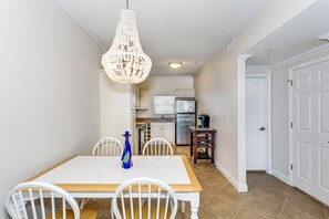 Enjoy meals in this cozy dining area with a central light fixture, table, and chairs.