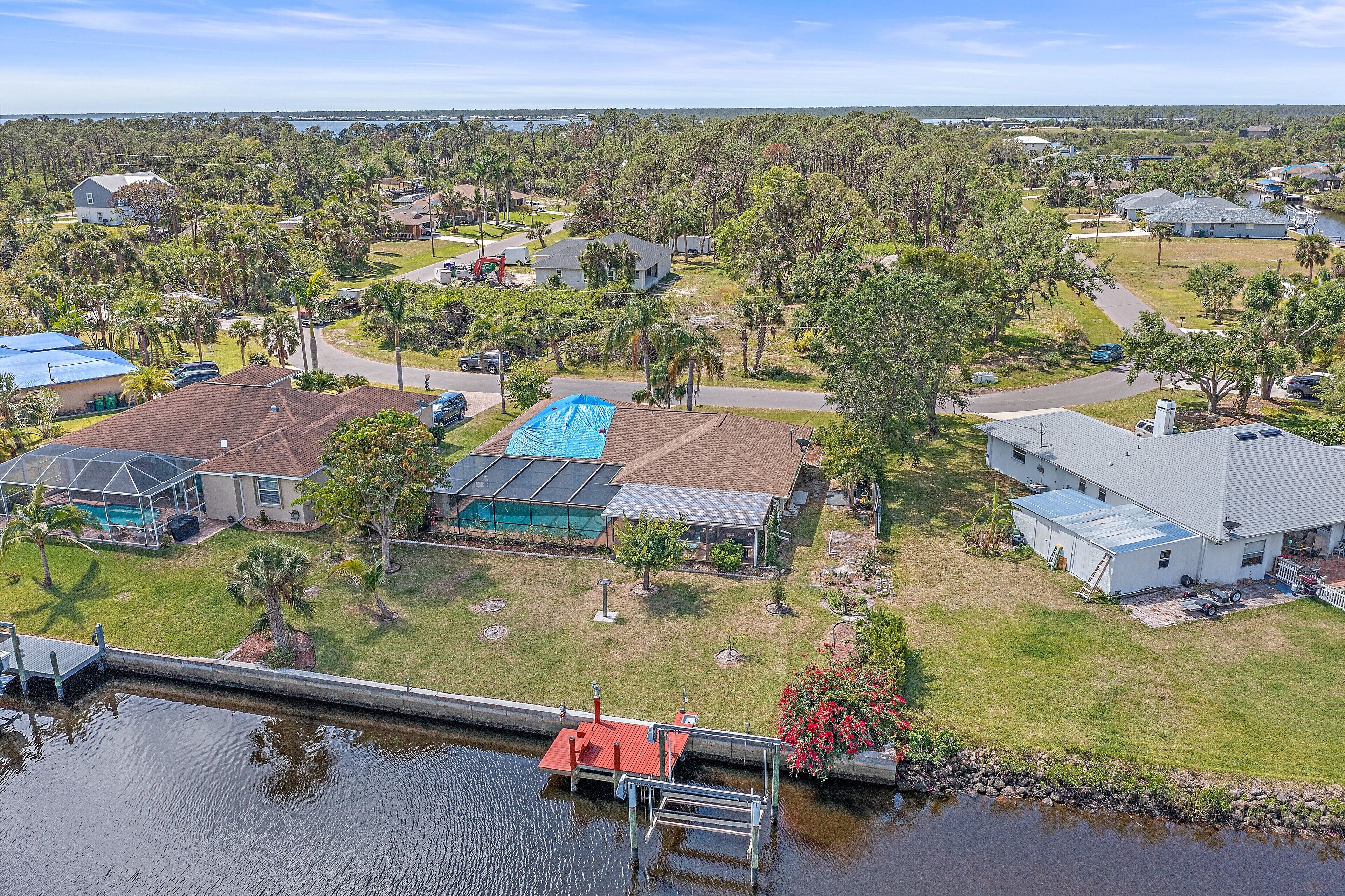 A residential area with houses, a dock, and a body of water.