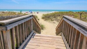A wooden boardwalk leading to a beach with a clear sky. - N Hampton 1609 in Kingston, Oceanview, Pool, Beach (Myrtle Beach)