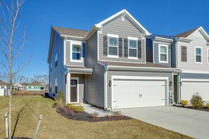A two-story house with a garage, a front yard, and a clear blue sky. - 3 Mi to Bethany Beach: 'The Chief’s Quarters' Home (Ocean View)