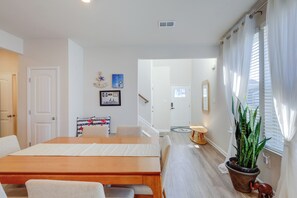 A modern hotel room with a wooden dining table, a sofa, a potted plant, and a staircase leading to another room. - 3 Mi to Bethany Beach: 'The Chief’s Quarters' Home (Ocean View)