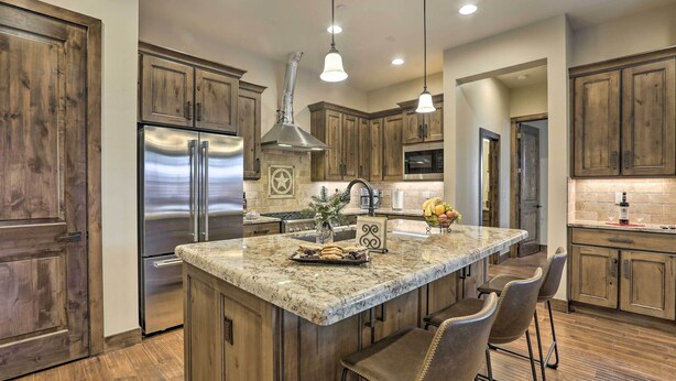 A kitchen with wooden cabinets, stainless steel appliances, a granite countertop, and pendant lighting. - 1/2 Mi to Dtwn: Golden Gem w/ Patios! (Golden)