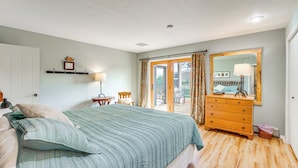 A bedroom with a bed, dresser, and a window with curtains. - Hot Tub, Wineries, Mtn Views: Palisade Home! (Palisade)