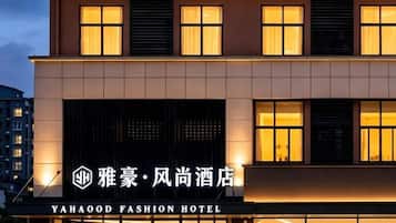 A hotel building with illuminated signage and a modern facade.