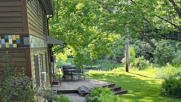 A garden pathway leading to a wooden house with a deck and outdoor furniture. - Spacious, private and peaceful 1st floor Apartment on Fly Creek  (Fly Creek)