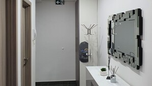 A modern bathroom with a vanity, a mirror, and a ceiling light. - Apartment Pallaton (Nasice)