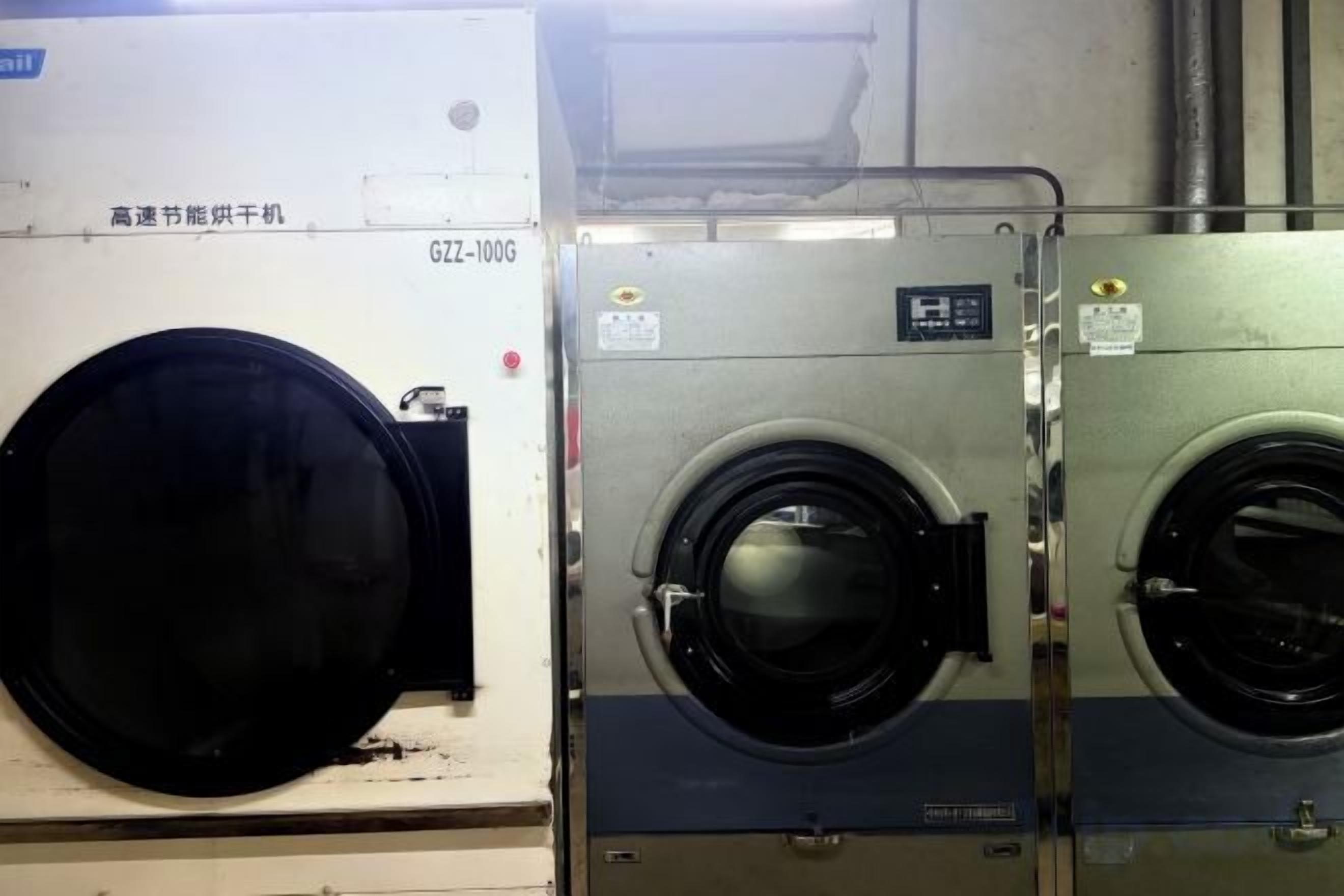 A large industrial machine with two large black circular components, likely part of a washing or drying system.