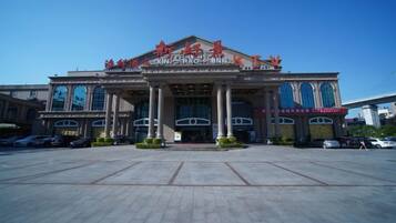 A large building with a central entrance, columns, and a clear sky.