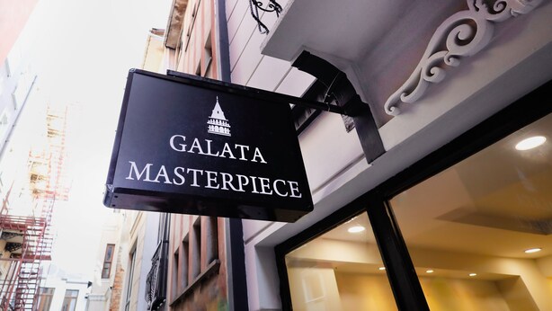 A sign for "GALATA MASTERPIECE" with a building facade in the background. - Galata Masterpiece Hotel (Istanbul)