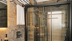 A modern bathroom with a glass-enclosed shower, a wooden vanity, and a marble-tiled floor. - Galata Masterpiece Hotel (Istanbul)