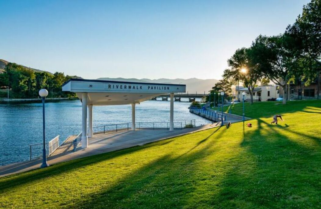A Riverwalk Pavilion with a view of the river and mountains in the background.