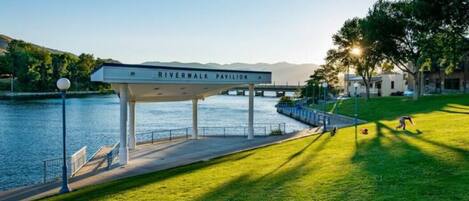 A Riverwalk Pavilion with a view of the river and mountains in the background.