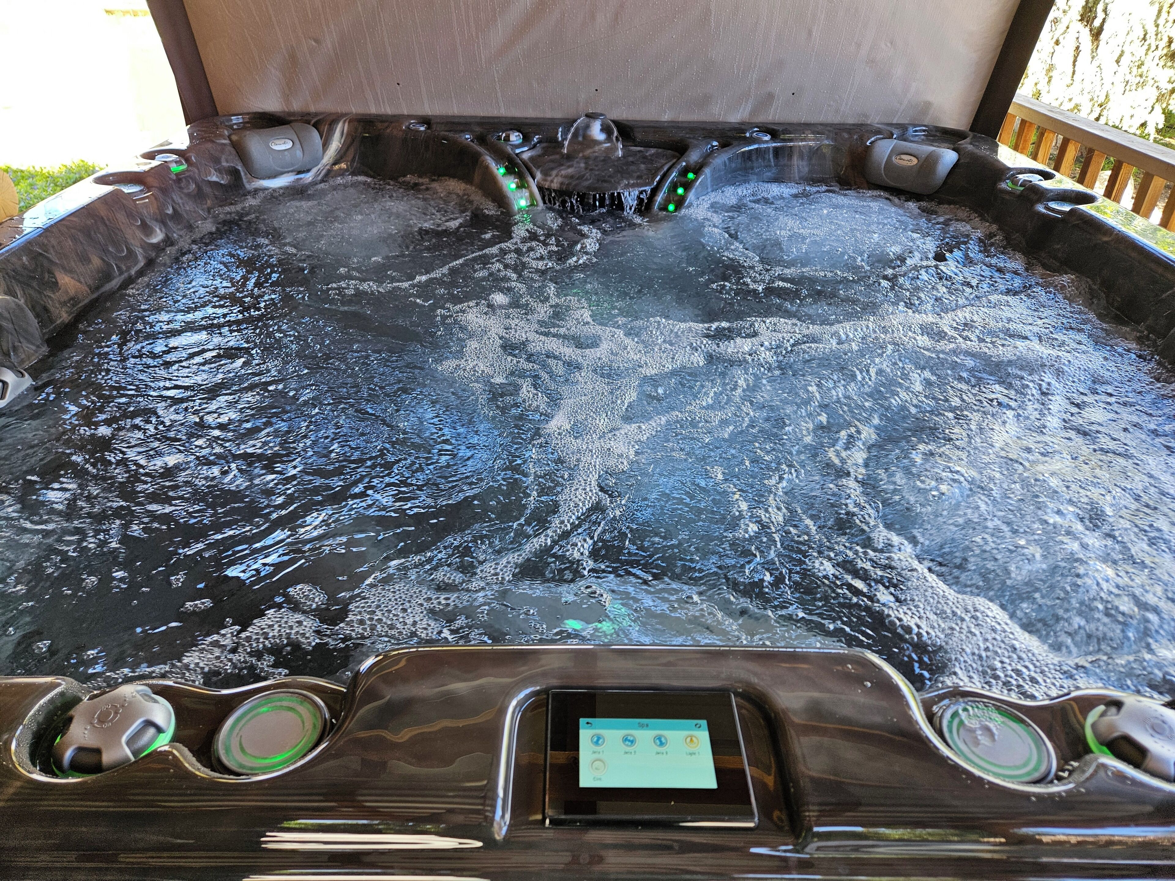A hot tub with a control panel and multiple jets.