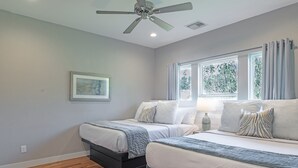 A bedroom with two beds, a ceiling fan, a window with curtains, and a framed picture on the wall. - 3BR Comfy Bungalow 1747! Medical Center, Stadiums! ⭐️⭐️⭐️⭐️⭐️ (Houston)