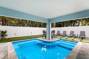 A heated pool, sun loungers
