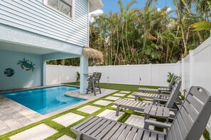 A heated pool, sun loungers