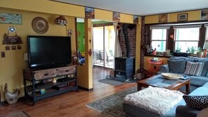 Uma sala de estar acolhedora, com televisão, sofá e lareira.