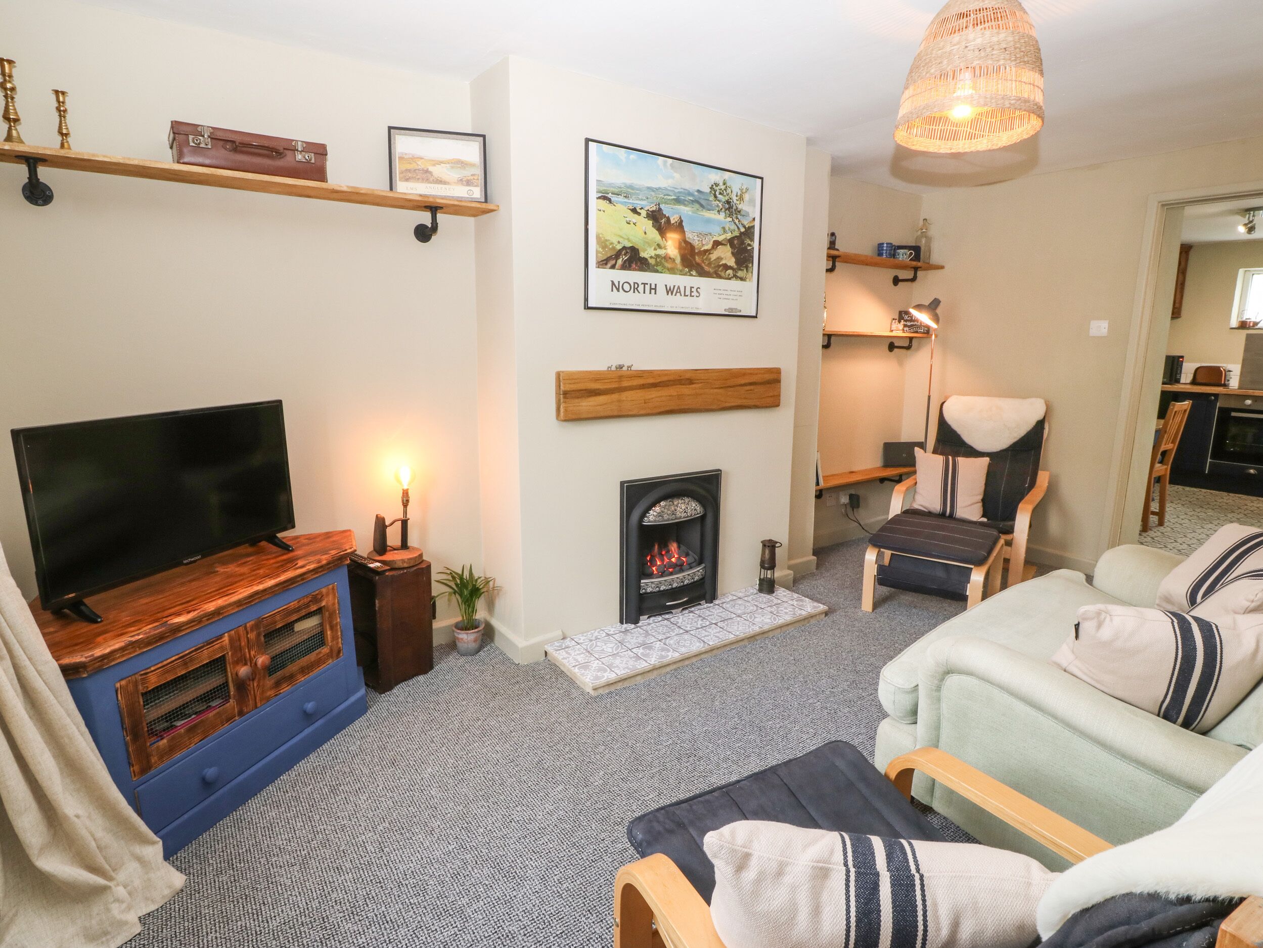 A cozy living room with a fireplace, a television, and a comfortable seating area.