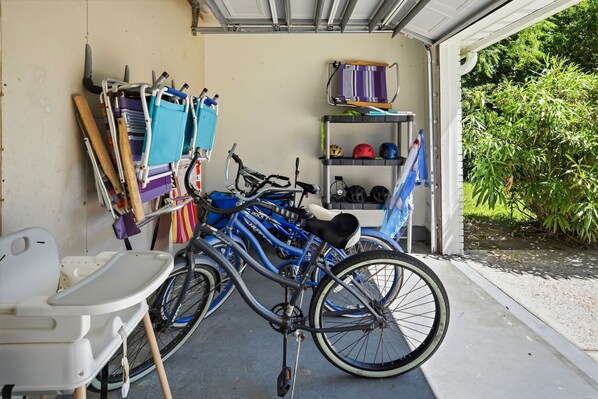 A garage with bicycles, helmets, and a baby stroller. - RENOVATED BEACH HOUSE WITH PRIVATE POOL. CLOSE TO THE BEACH! GAME ROOM! (Panama City Beach)