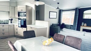 A compact living space with a kitchenette, dining area, and seating area.