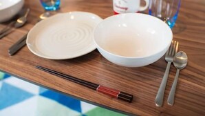 A table with a white plate, a bowl, chopsticks, a spoon, and a fork. - SHATOREYOYOGI401 (Tokyo)