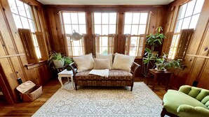 A cozy room with a patterned rug, wooden furniture, and large windows. - Classy home w/ deck & fenced yard only 2 blocks from the fairgrounds!! (Tulsa)