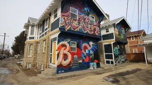 Un immeuble de deux étages orné d’une grande fresque sur l’un de ses murs.
