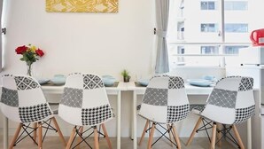 A dining area with four chairs, a table, and a vase with flowers. - SHATOREYOYOGI (Tokyo)