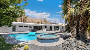 A modern house with a swimming pool, a hot tub, and a patio area with cacti and rocks. - Fairway Luxe: New Remodel on Indian Canyons Course (Palm Springs)
